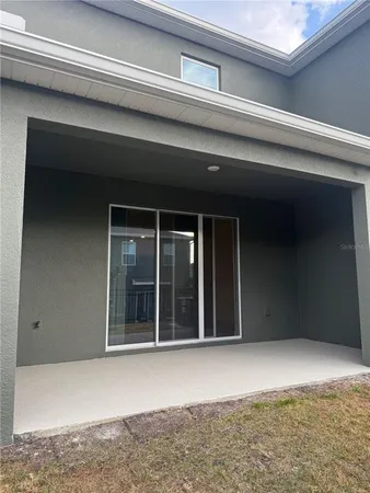 a kitchen with granite countertop a refrigerator and cabinets