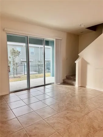 a view of room with window and flat screen tv