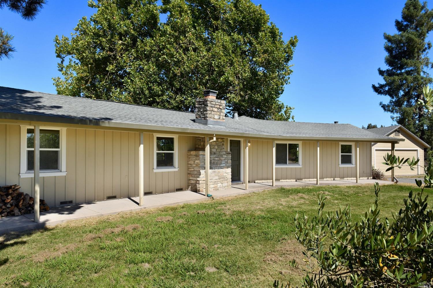 a front view of house with yard and green space