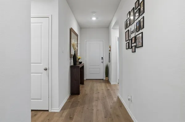 a view of a hallway with wooden floor