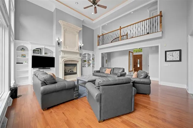 a living room with furniture a flat screen tv and a fireplace