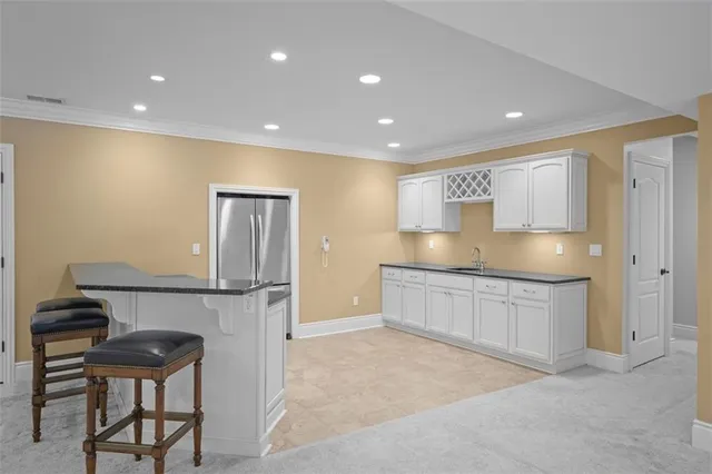 a large kitchen with stainless steel appliances granite countertop a granite counter tops and a refrigerator