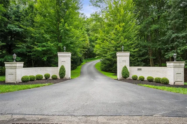 a view of a street with a small yard