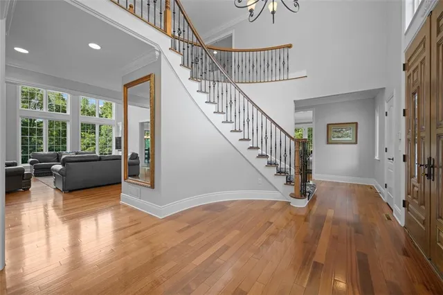 a view of entryway and hall with wooden floor