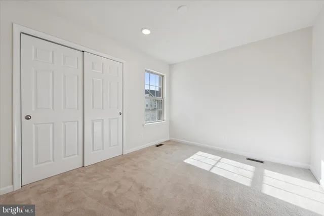 a kitchen with stainless steel appliances granite countertop a sink and a refrigerator