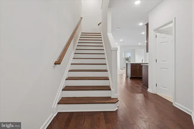 a view of entryway and hall with wooden floor