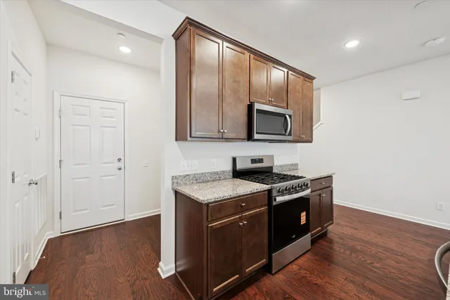 a view of kitchen with furniture and a refrigerator