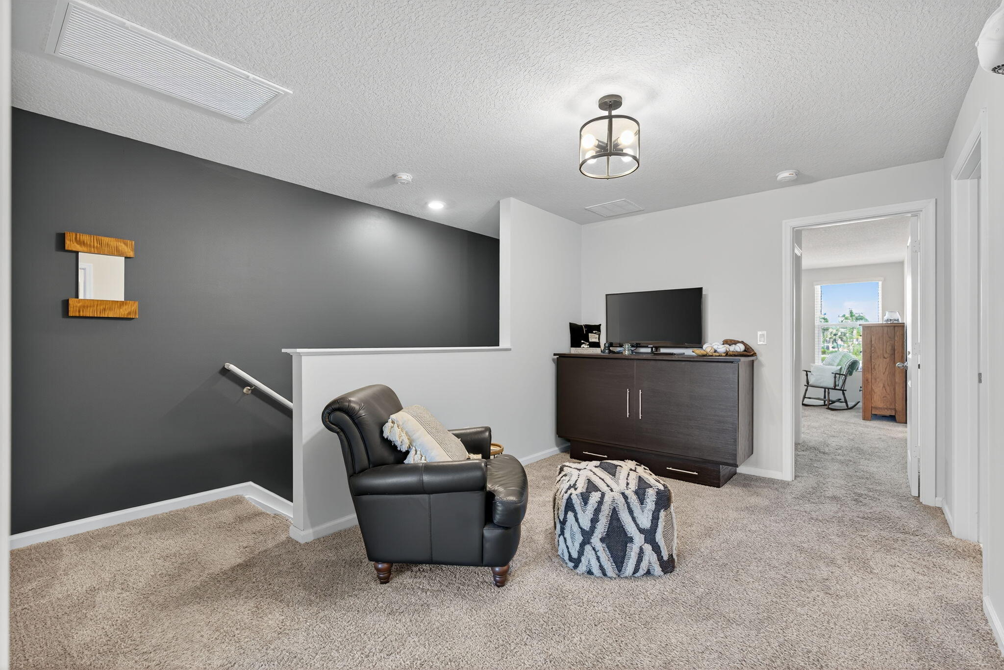 3942 Southeast Caladium Court Stuart, FL 34997 - Photo 13 of 38 a living room with furniture and a flat screen tv
