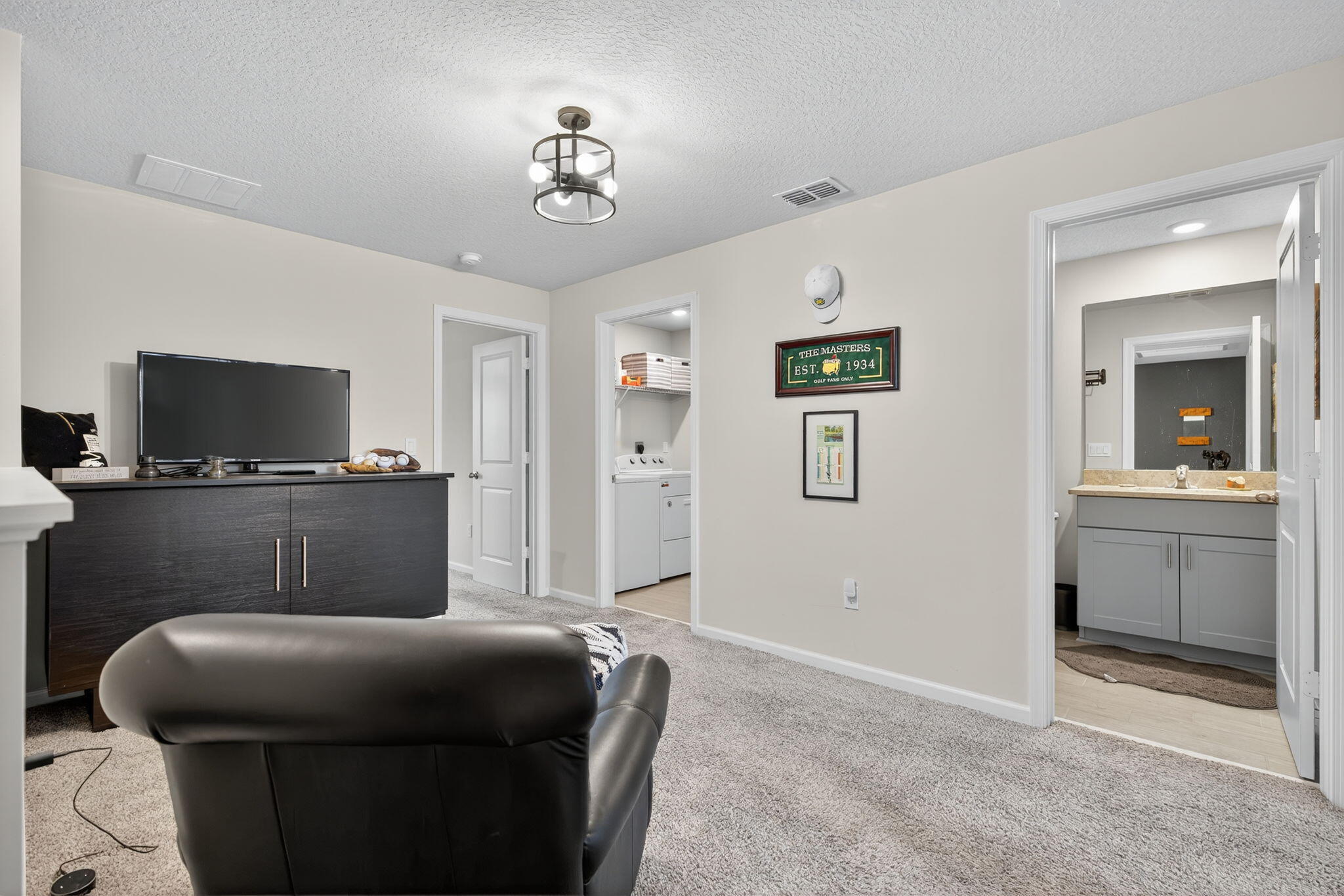 3942 Southeast Caladium Court Stuart, FL 34997 - Photo 15 of 38 a living room with furniture and a flat screen tv