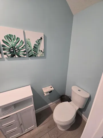 a bathroom with a sink toilet and mirror