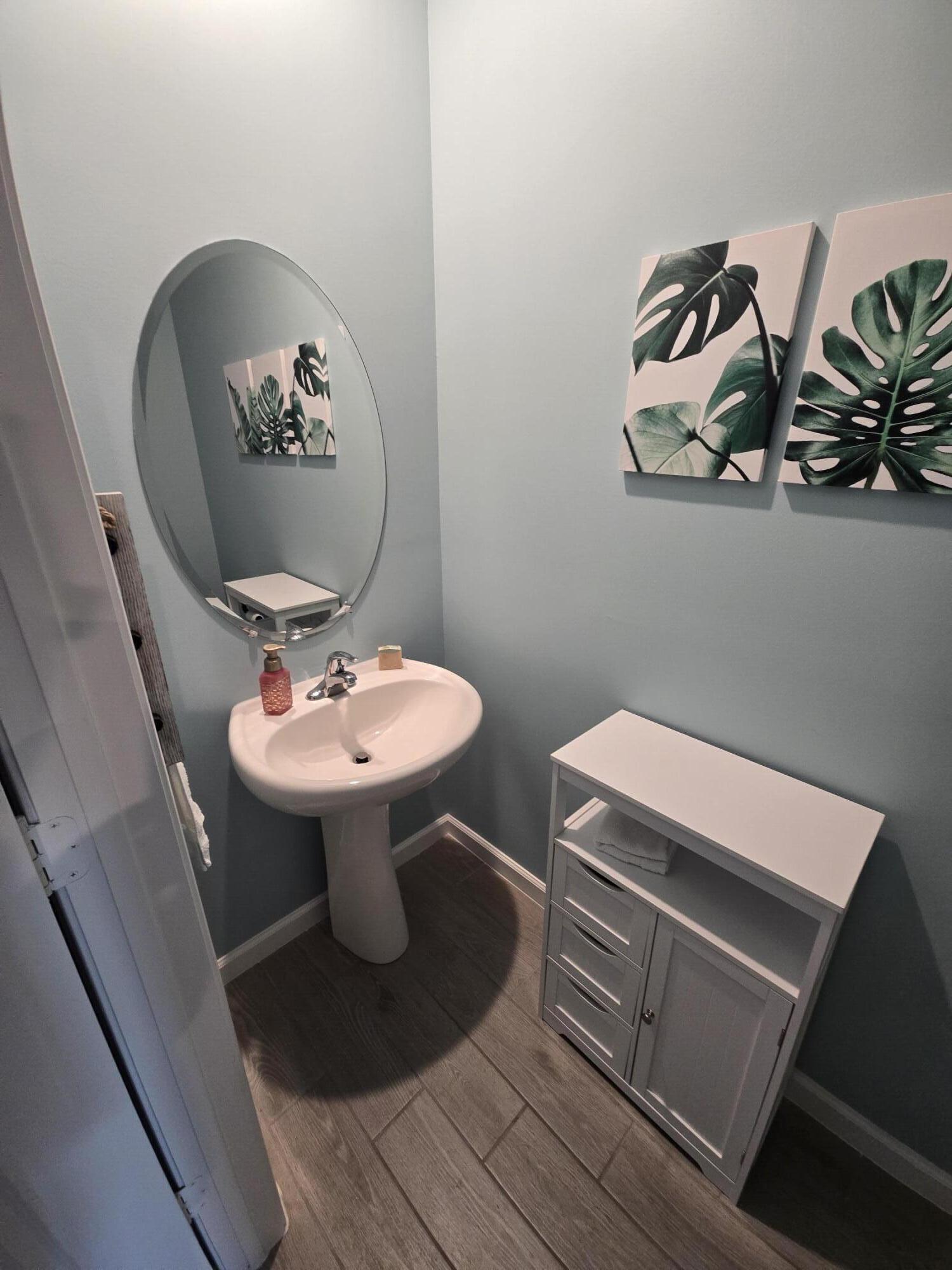 3942 Southeast Caladium Court Stuart, FL 34997 - Photo 19 of 38 a bathroom with a sink toilet and mirror