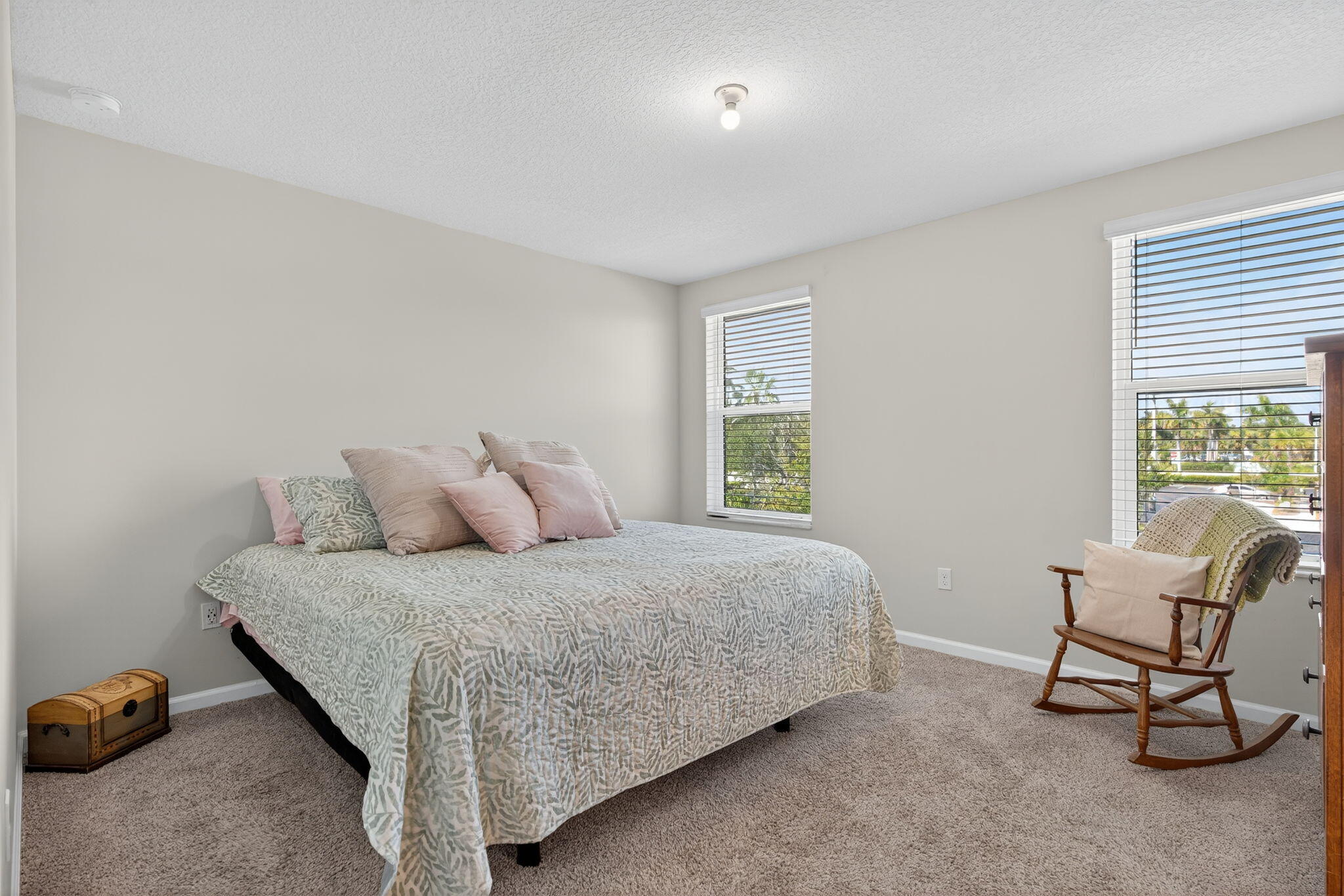 3942 Southeast Caladium Court Stuart, FL 34997 - Photo 20 of 38 a bedroom with a bed chair and window