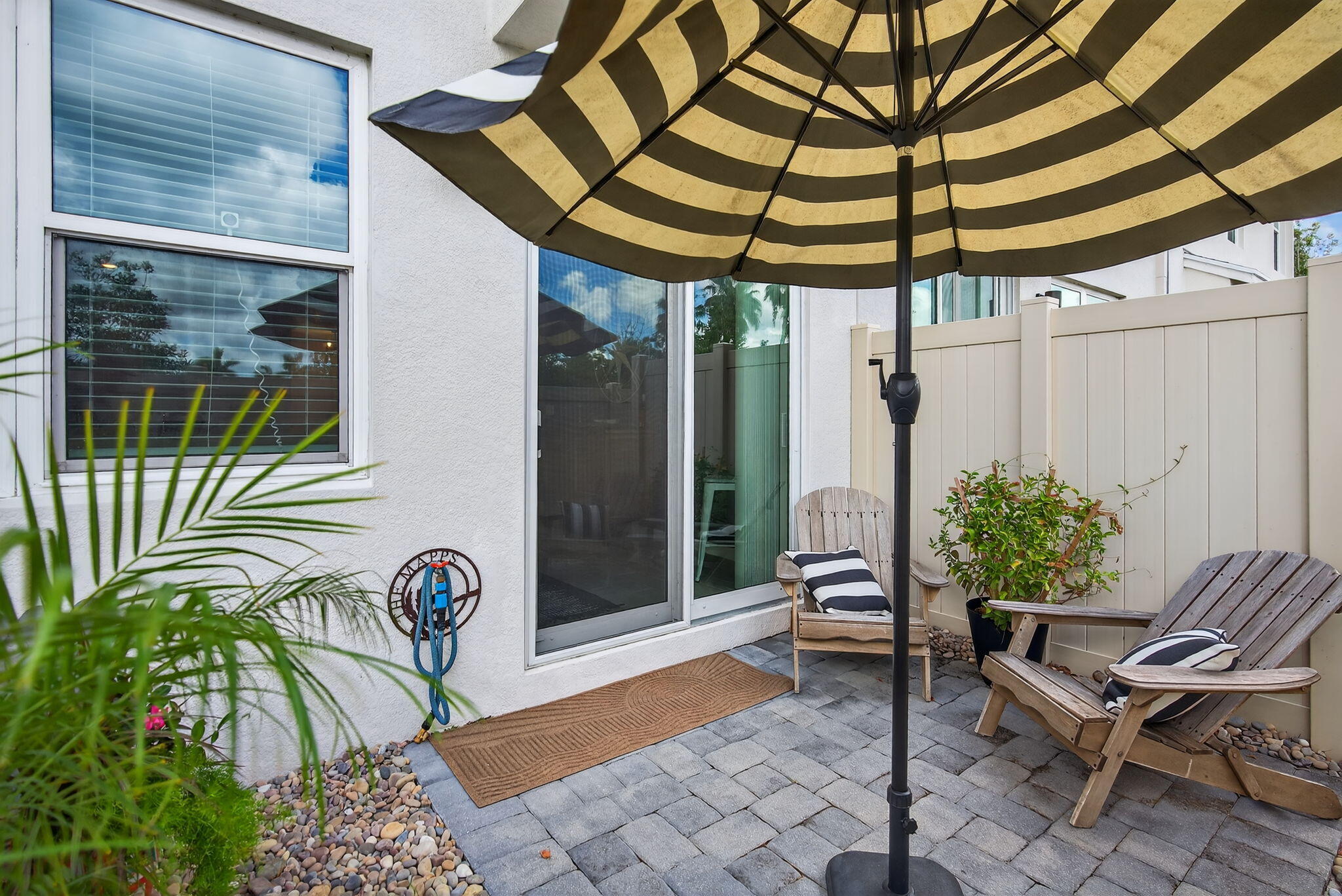 3942 Southeast Caladium Court Stuart, FL 34997 - Photo 35 of 38 a patio with a table and chairs