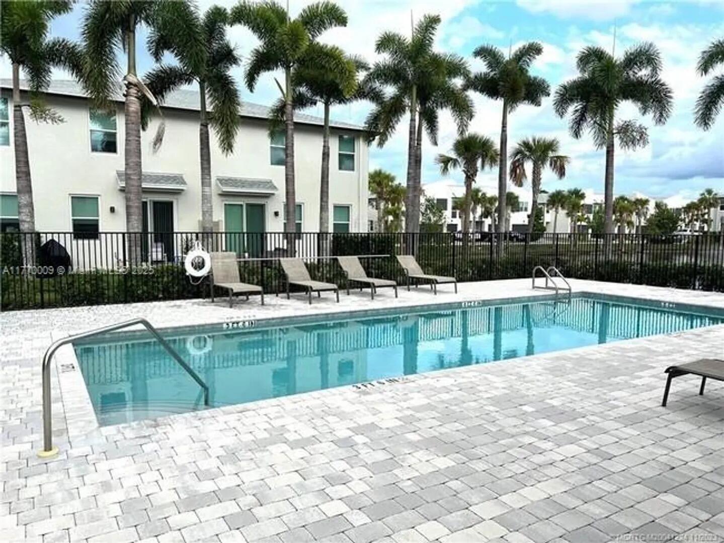 3942 Southeast Caladium Court Stuart, FL 34997 - Photo 37 of 38 a swimming pool with outdoor seating and yard