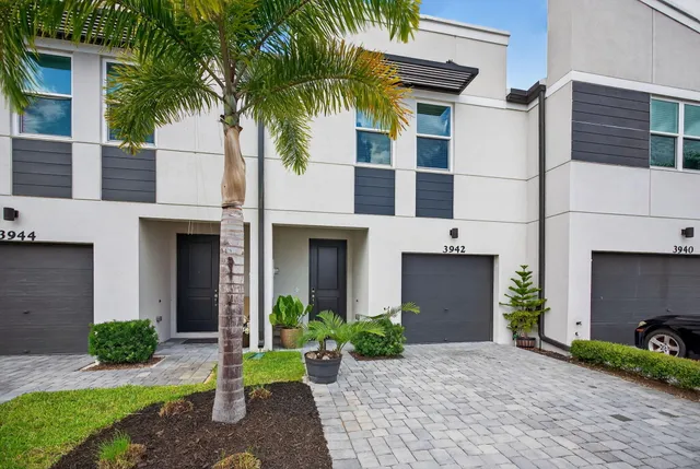 a front view of a house with a yard and a garage
