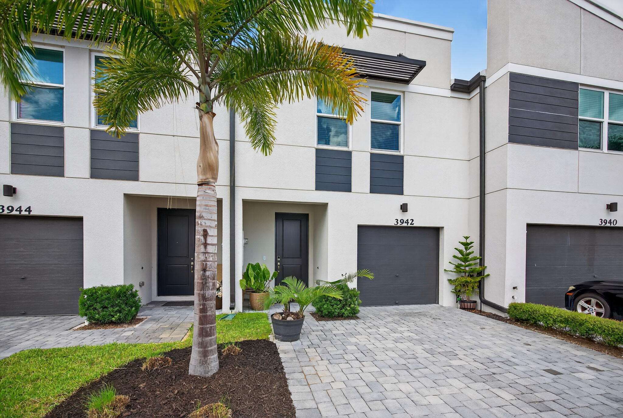 3942 Southeast Caladium Court Stuart, FL 34997 - Photo 5 of 38 a front view of a house with a yard and a garage