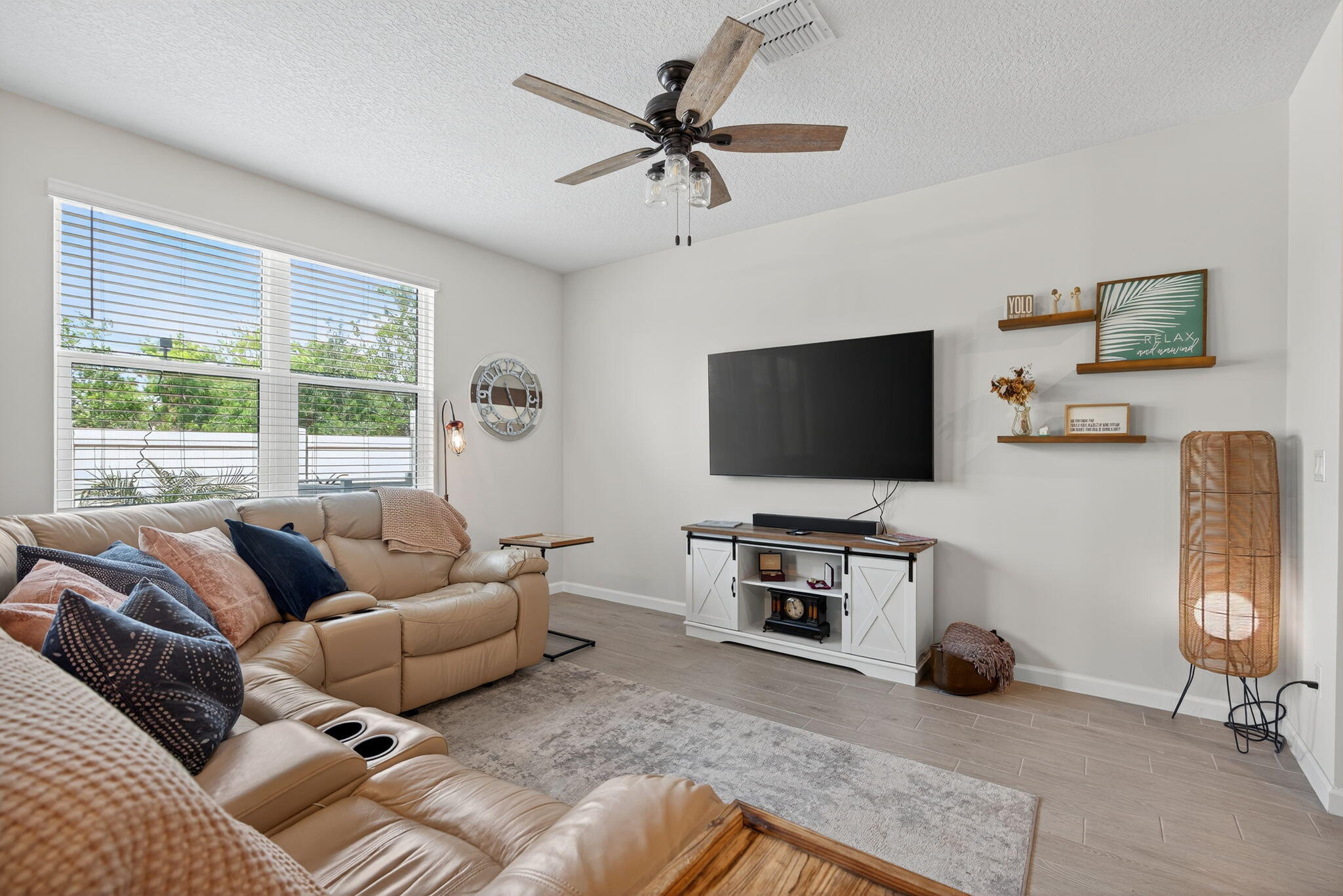 3942 Southeast Caladium Court Stuart, FL 34997 - Photo 6 of 38 a living room with furniture and a flat screen tv