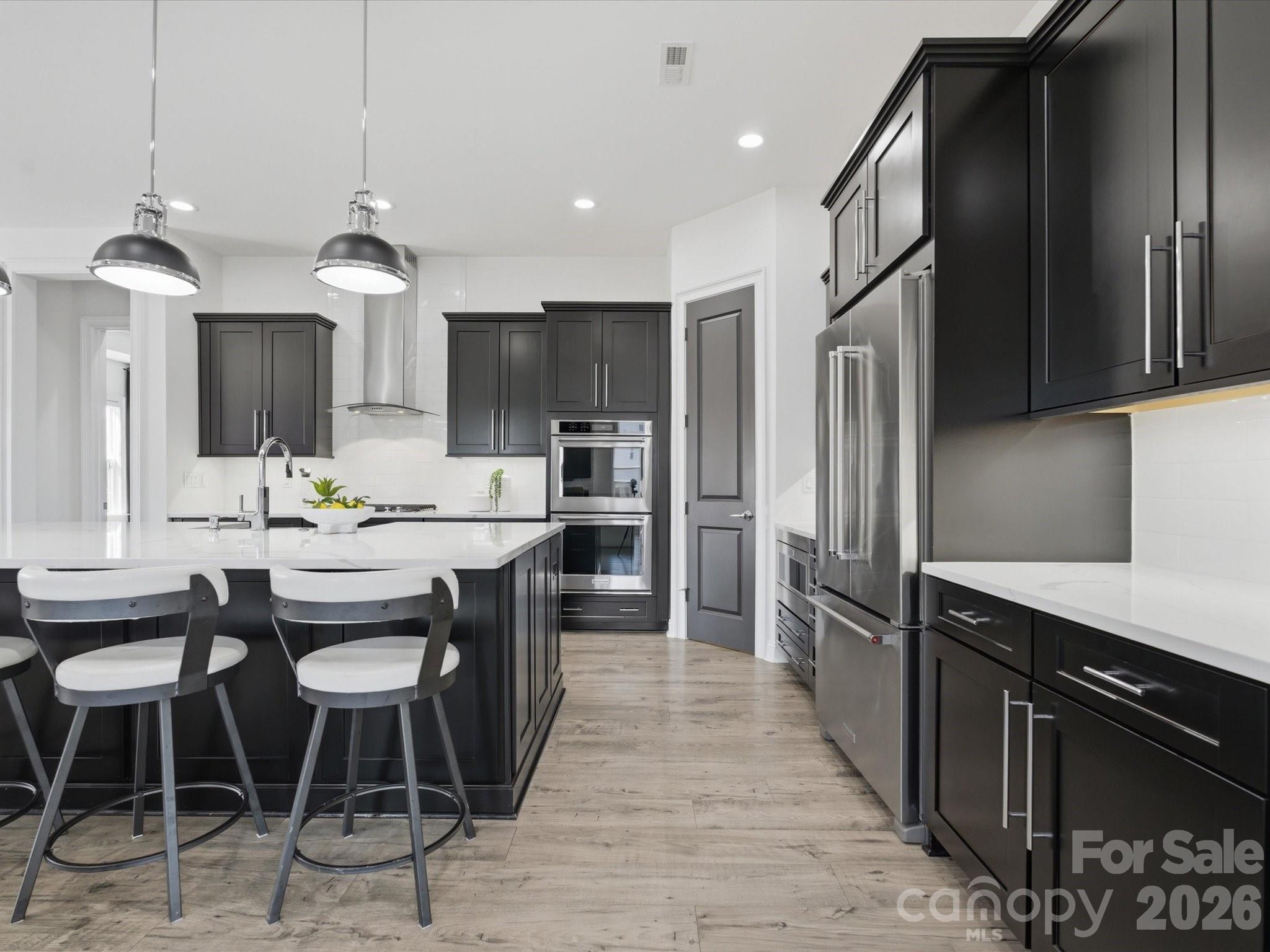 7237 Twelve Mile Creek Road Lancaster, SC 29720 - Photo 11 of 47 a kitchen with stainless steel appliances kitchen island granite countertop a sink refrigerator and cabinets