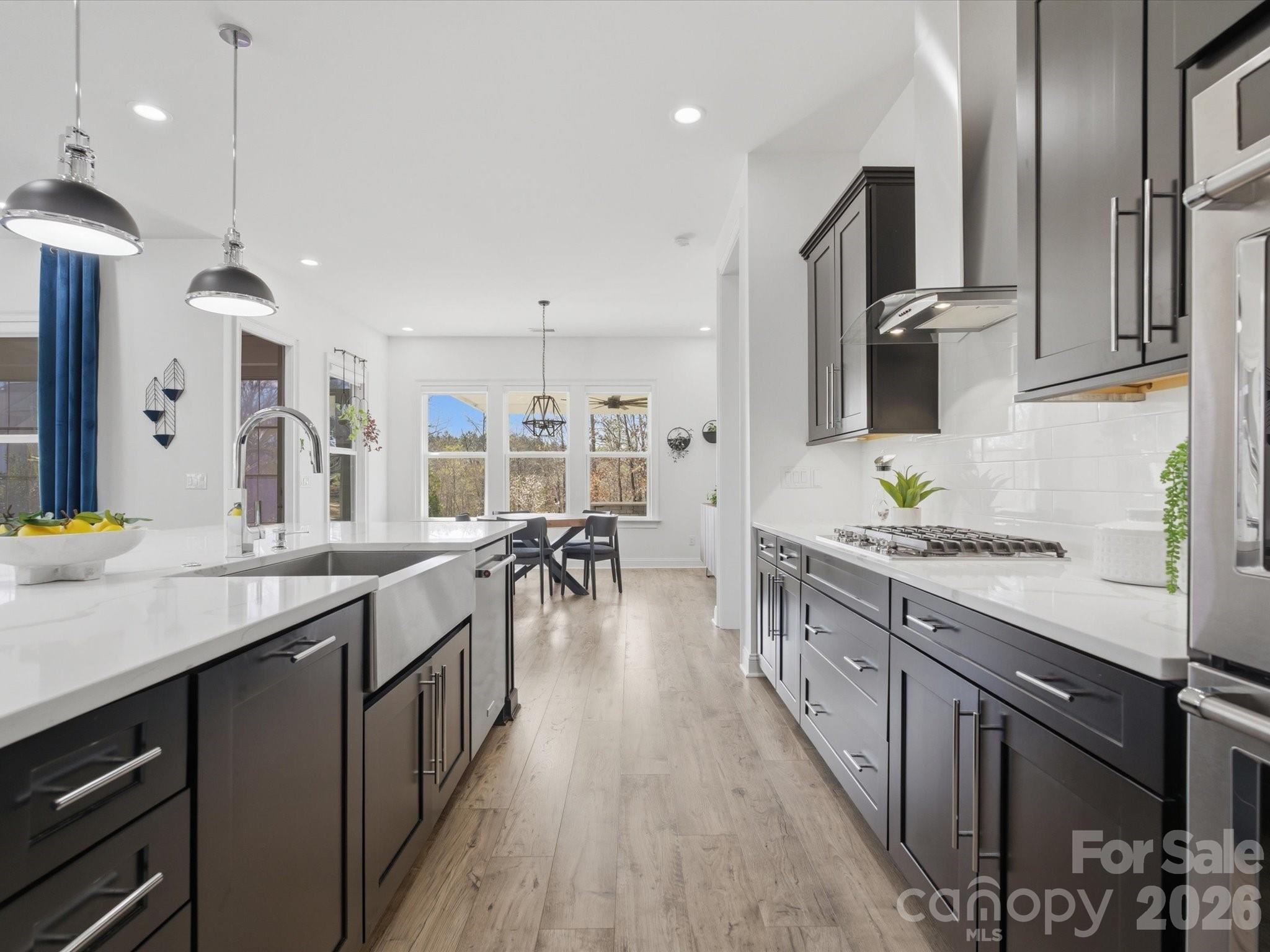 7237 Twelve Mile Creek Road Lancaster, SC 29720 - Photo 18 of 47 a kitchen with stainless steel appliances granite countertop a lot of counter space and wooden floors