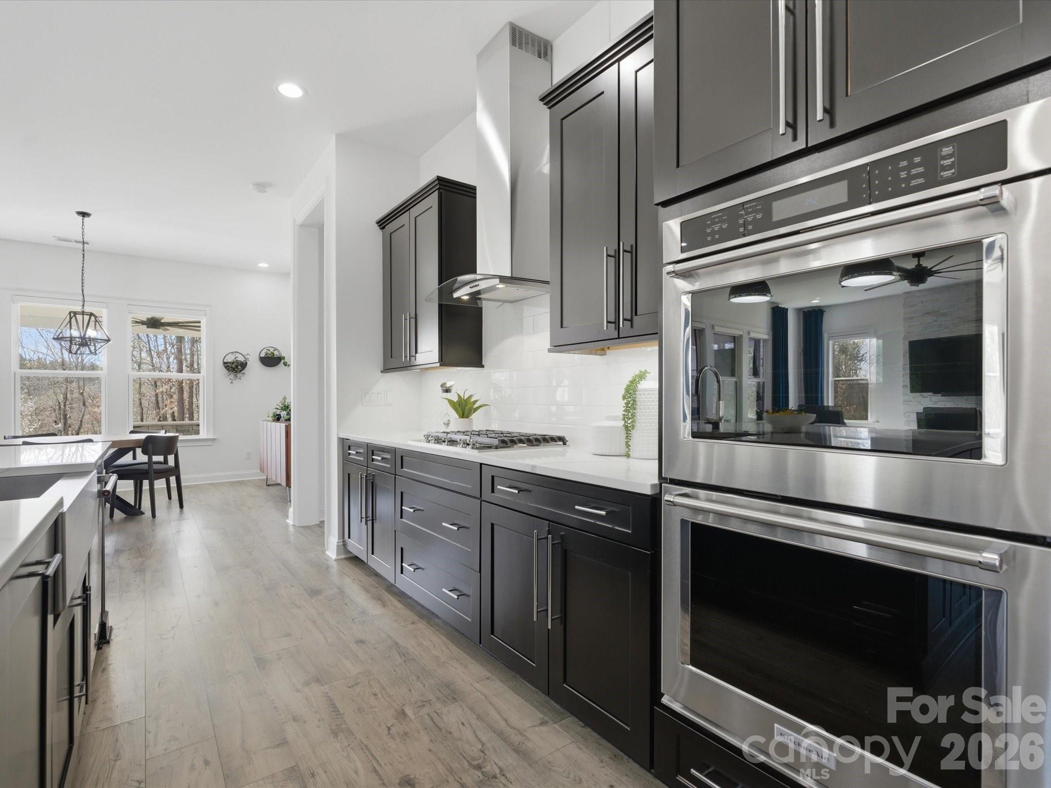 7237 Twelve Mile Creek Road Lancaster, SC 29720 - Photo 19 of 47 a kitchen with stainless steel appliances kitchen island granite countertop a stove a sink and a refrigerator
