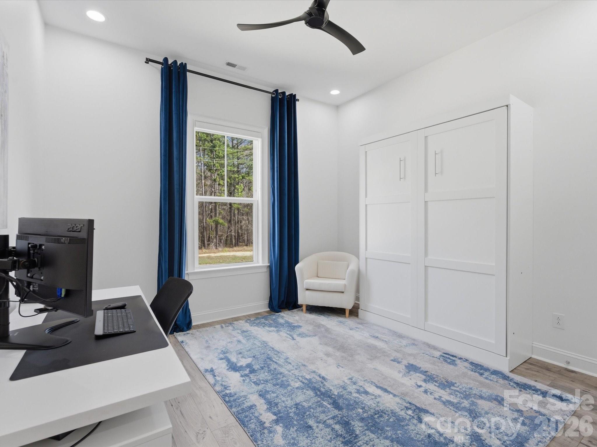 7237 Twelve Mile Creek Road Lancaster, SC 29720 - Photo 23 of 47 a bedroom with a bed wooden floor and a window