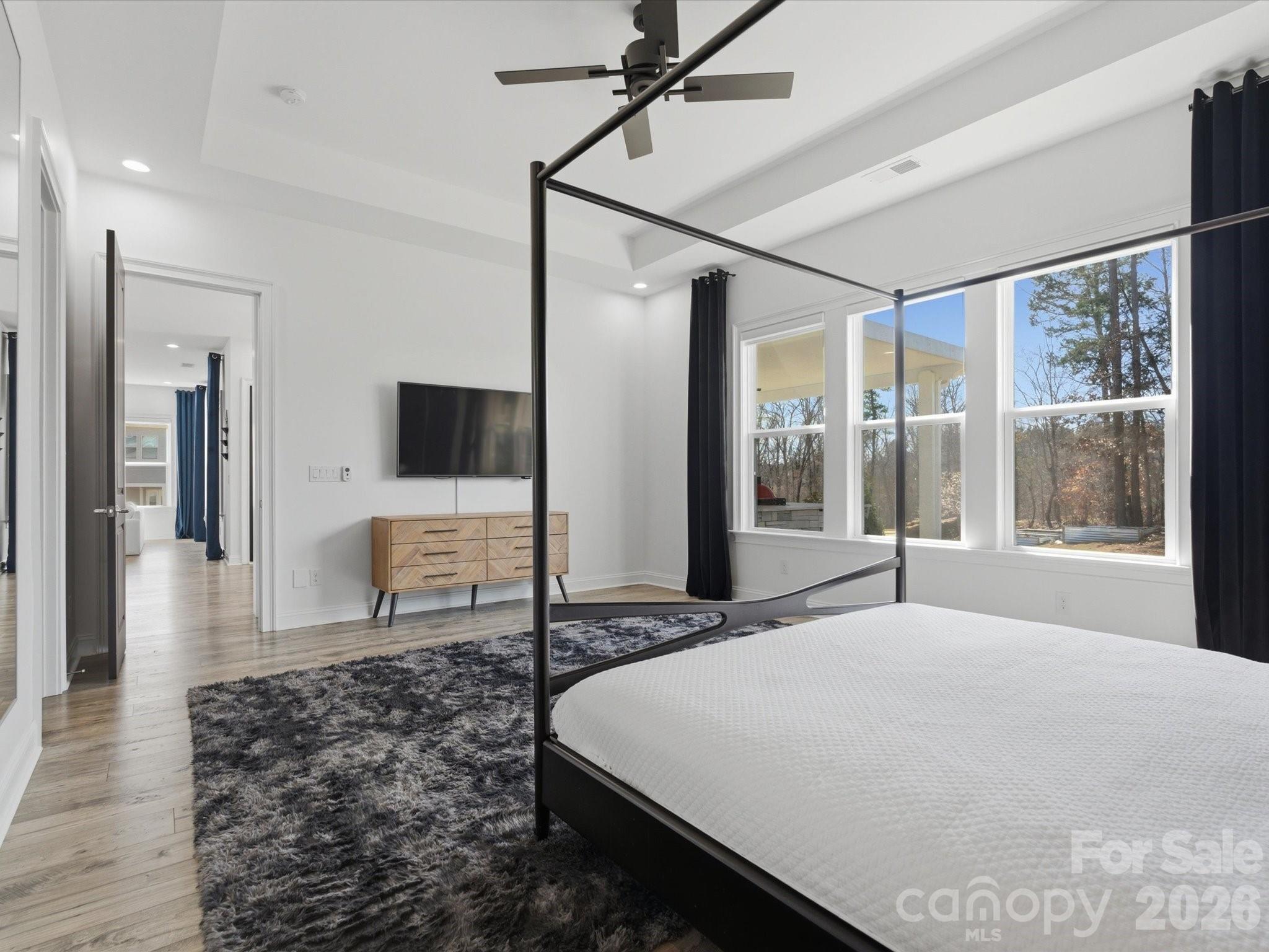 7237 Twelve Mile Creek Road Lancaster, SC 29720 - Photo 25 of 47 a spacious bedroom with a large bed and a flat screen tv