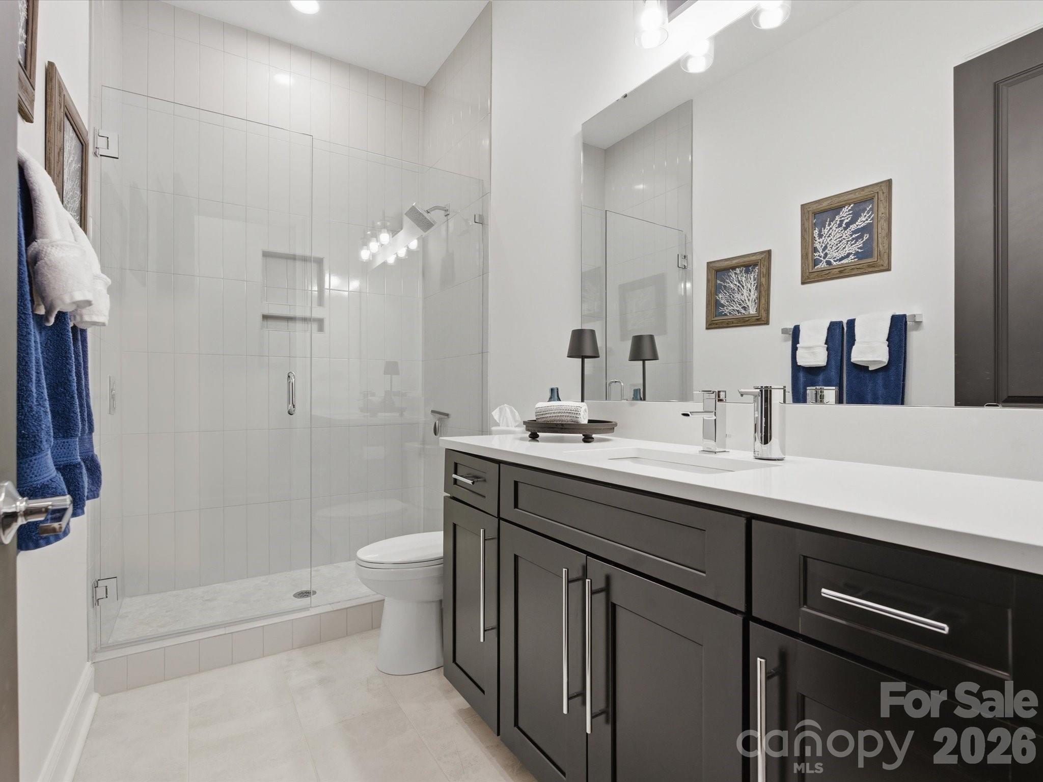 7237 Twelve Mile Creek Road Lancaster, SC 29720 - Photo 33 of 47 a bathroom with a double vanity sink toilet and shower