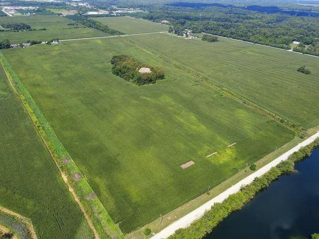 a view of a field with an ocean view