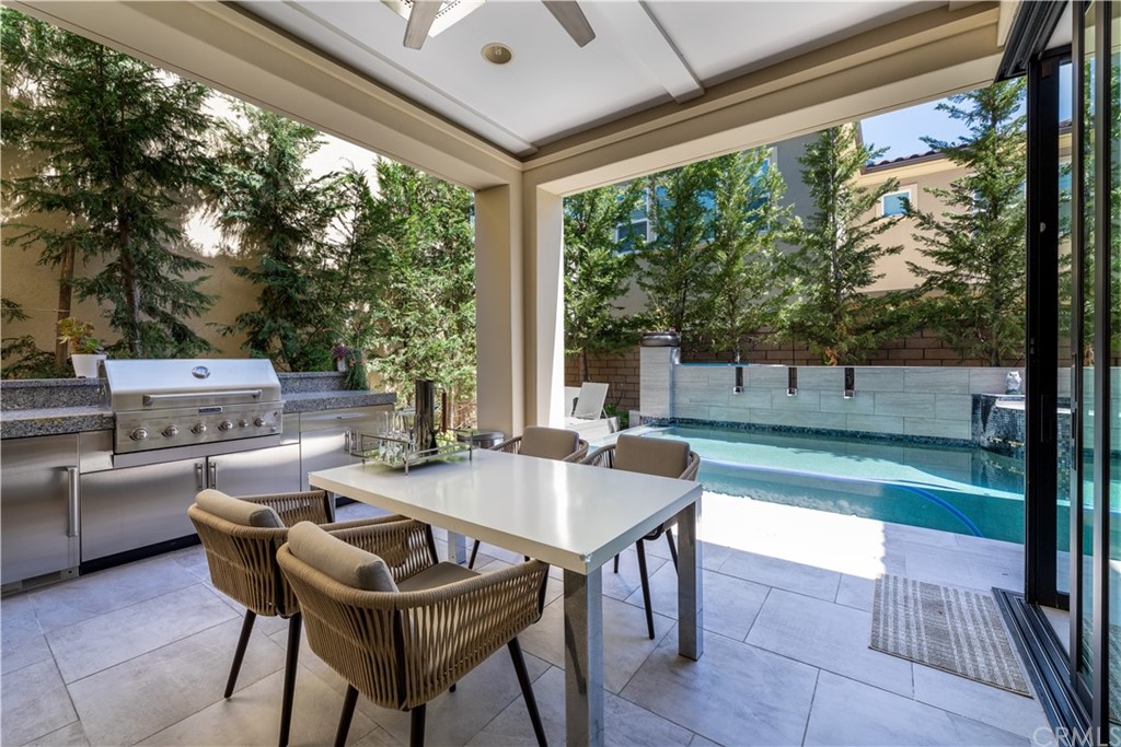 35 Zion Drive Lake Forest, CA 92630 - Photo 39 of 41 a view of a patio with table and chairs and couches with wooden floor and fence