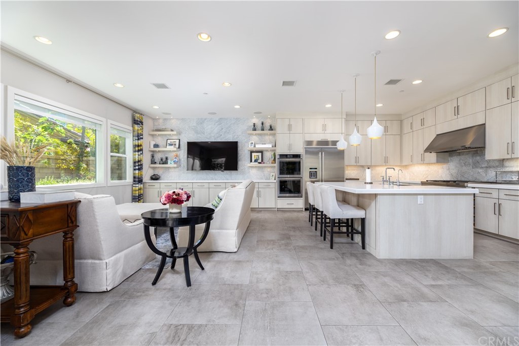 35 Zion Drive Lake Forest, CA 92630 - Photo 9 of 41 a living room with stainless steel appliances kitchen island granite countertop furniture and a flat screen tv
