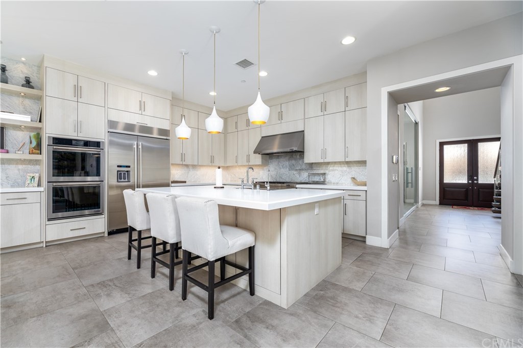 35 Zion Drive Lake Forest, CA 92630 - Photo 10 of 41 a large kitchen with cabinets chairs and refrigerator