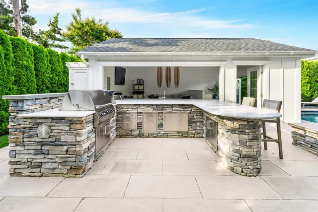 a view of a patio with table and chairs potted plants with wooden fence