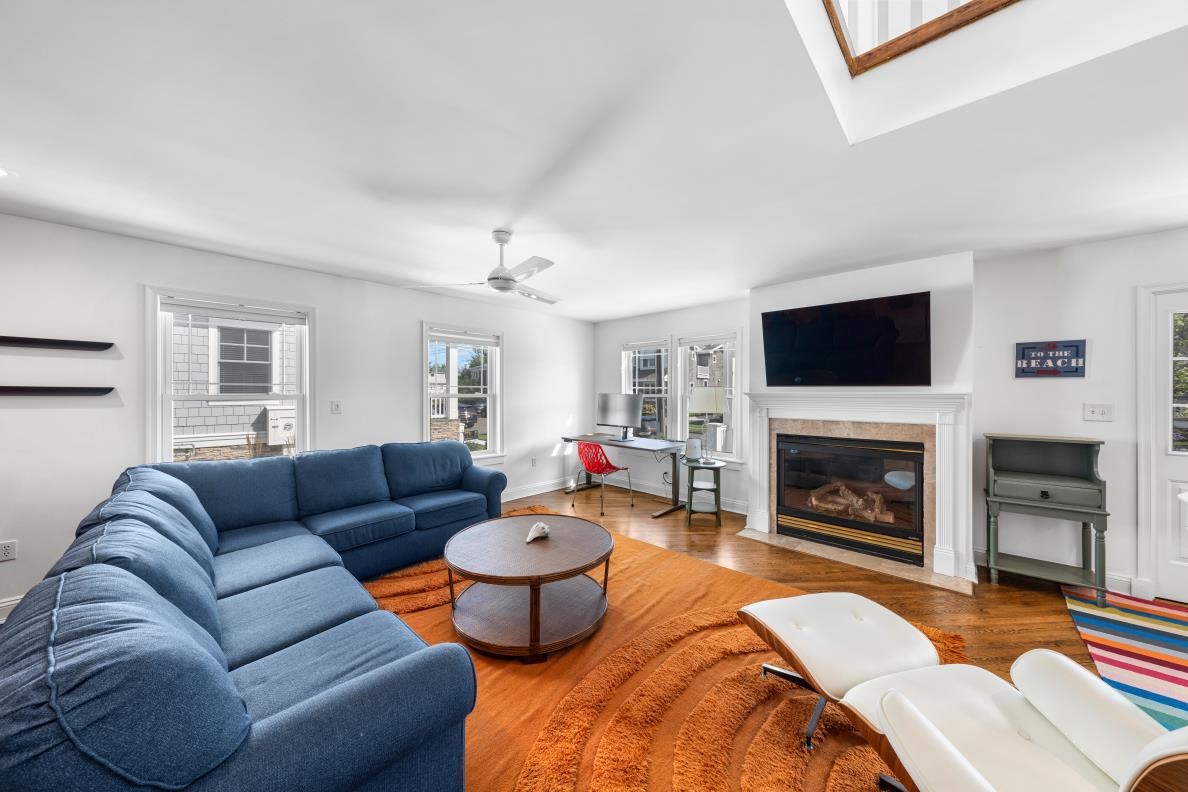 246 103rd Street Stone Harbor, NJ 08247 - Photo 17 of 50 a living room with furniture a flat screen tv and a fireplace
