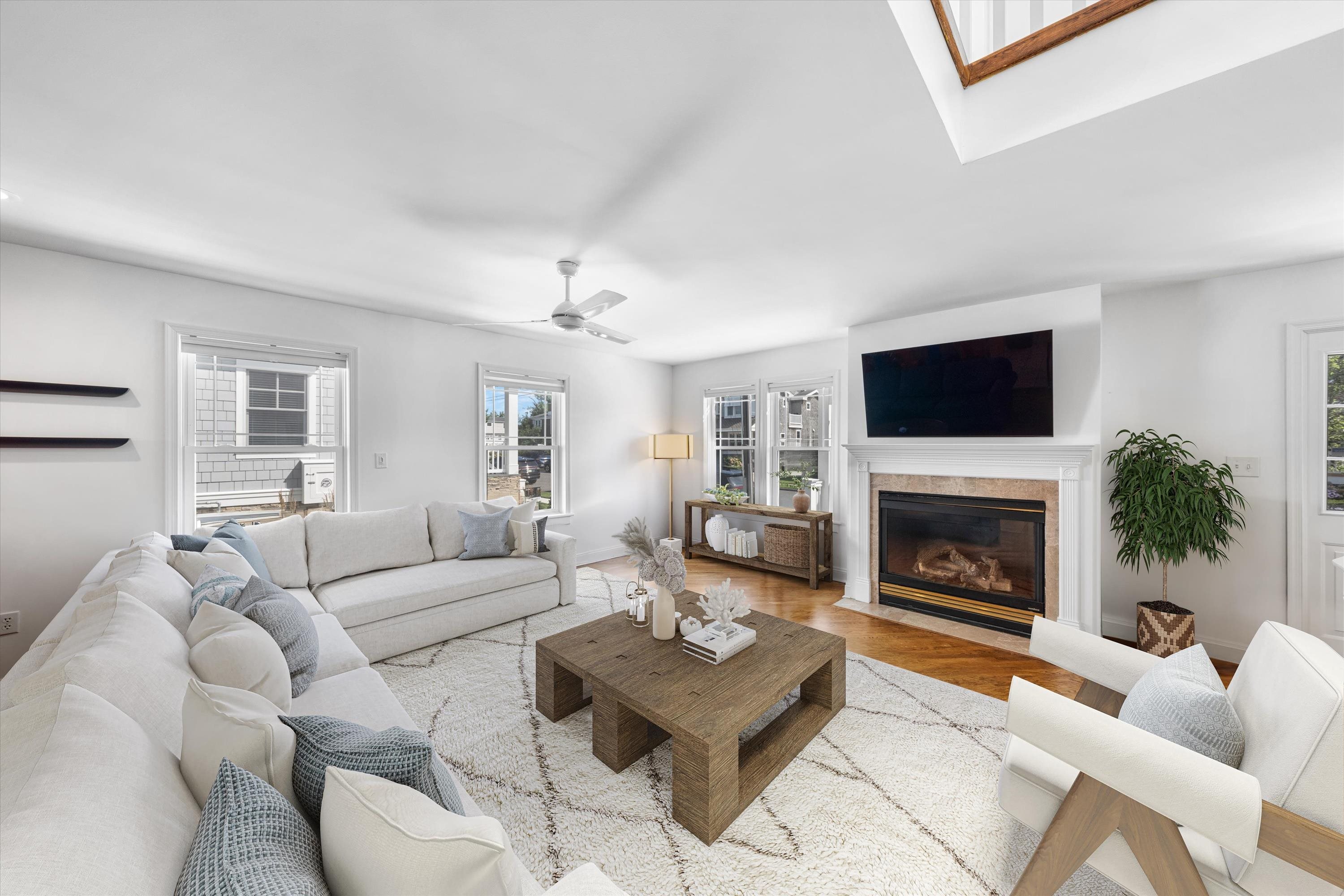 246 103rd Street Stone Harbor, NJ 08247 - Photo 18 of 50 a living room with furniture a flat screen tv and a fireplace
