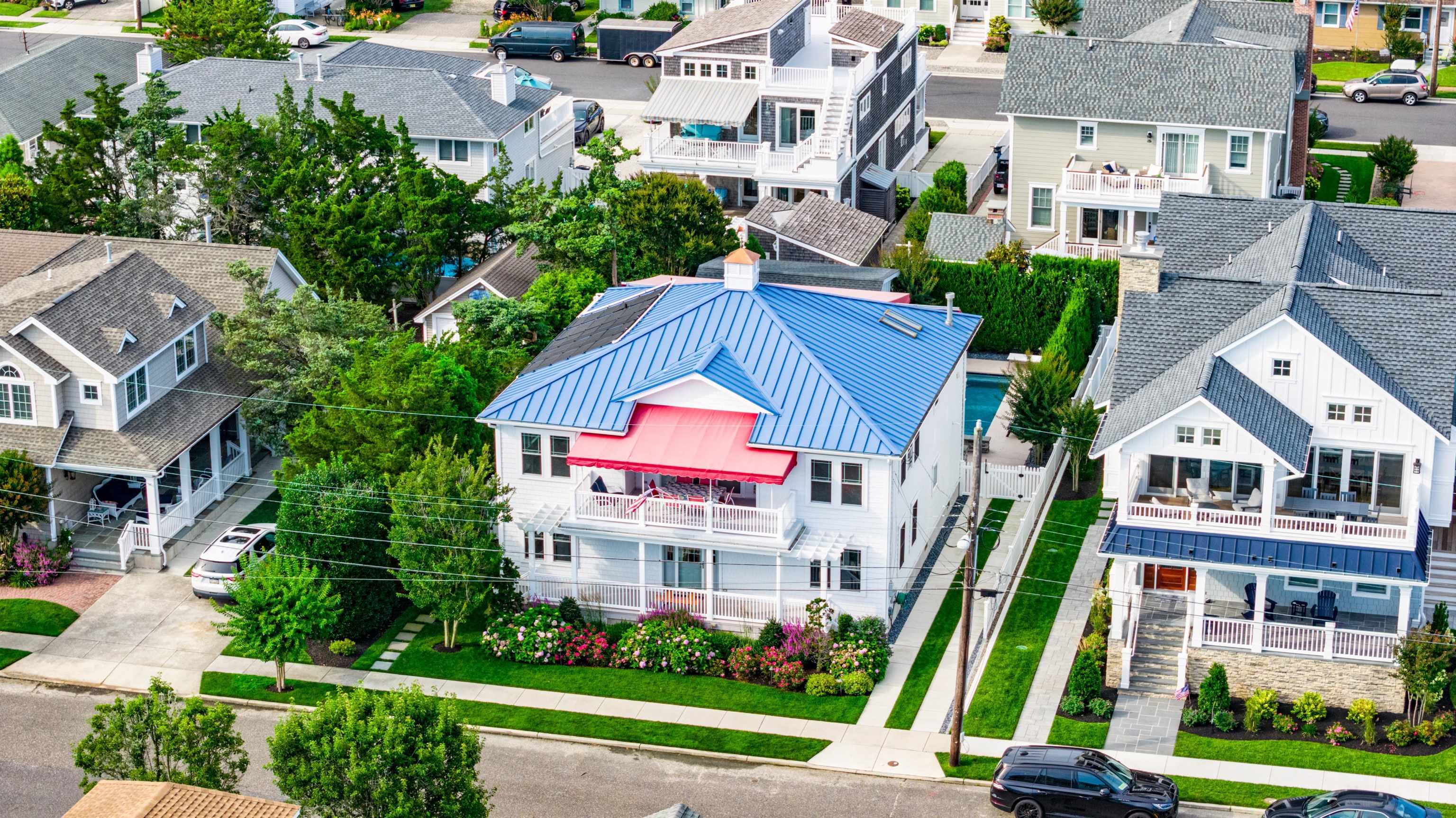 246 103rd Street Stone Harbor, NJ 08247 - Photo 2 of 50 a view of multiple houses with a yard and potted plants