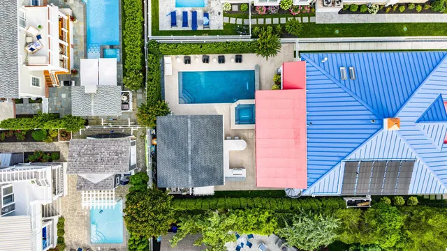 an aerial view of a house with a yard and potted plants
