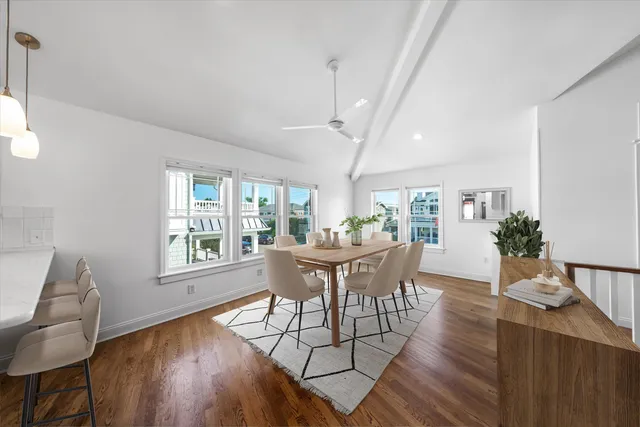 a dining room with furniture window and wooden floor