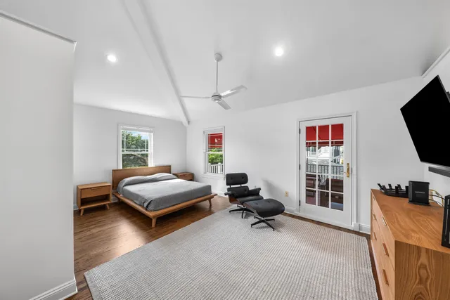 a bedroom with furniture and a flat screen tv