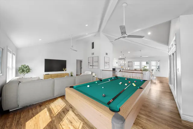 a room with kitchen view and a wooden floor