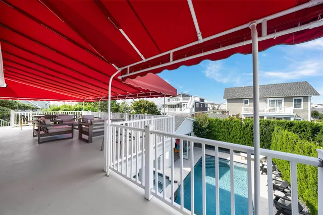 a view of a patio with a table and chairs under an umbrella