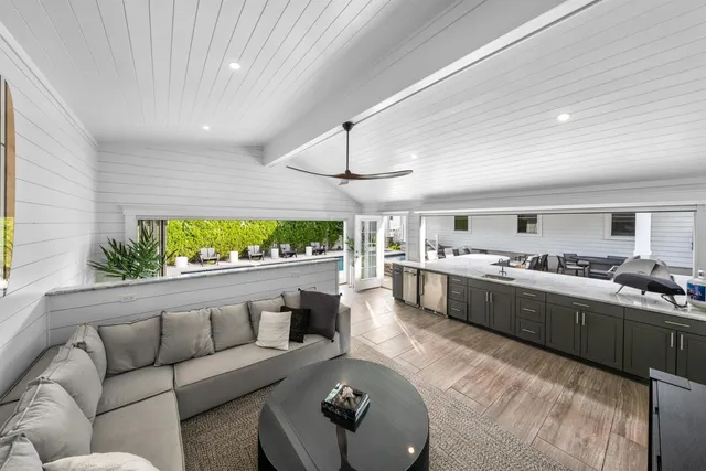 a living room with furniture and a kitchen view