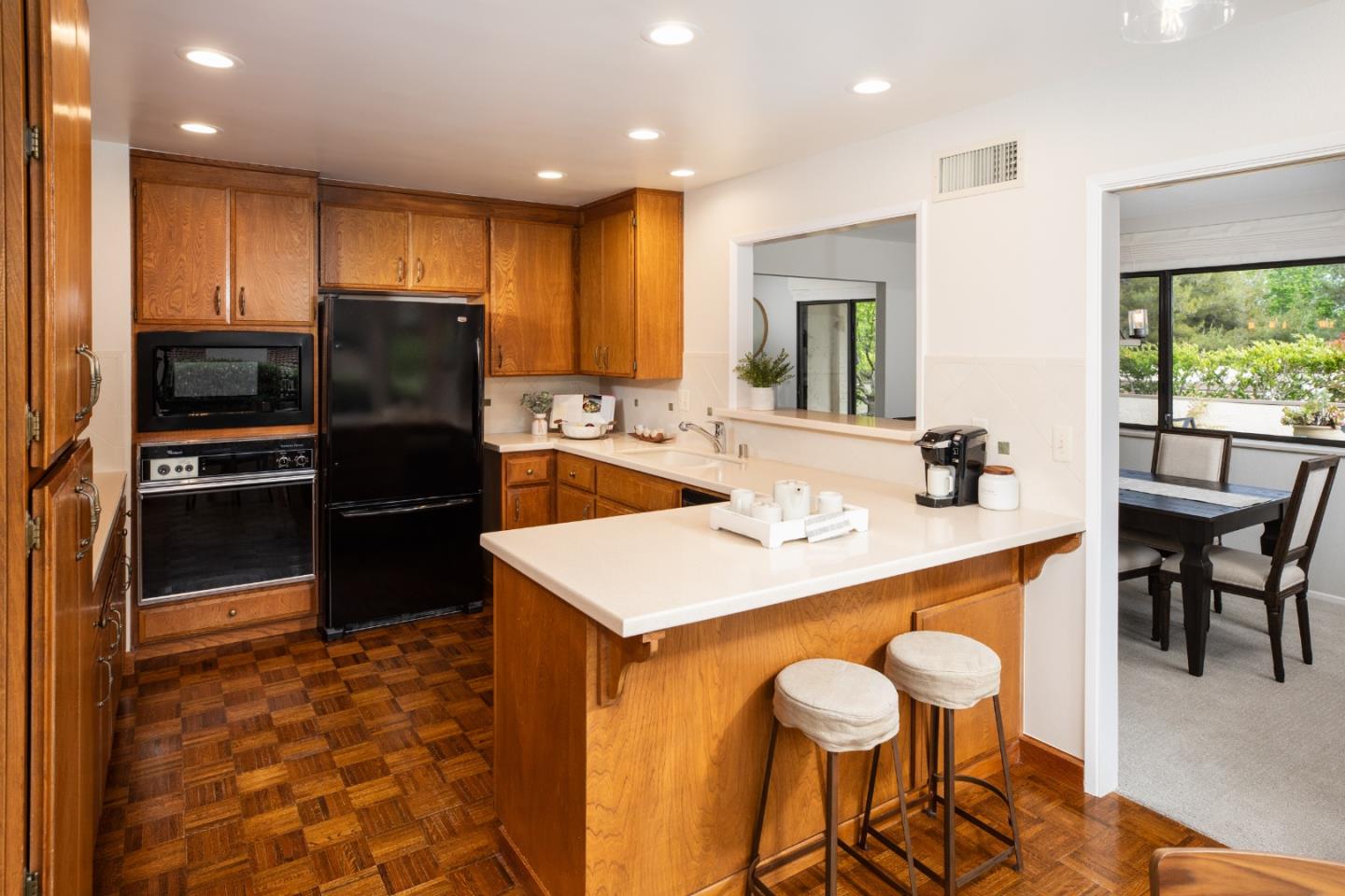 22415 Rancho Deep Cliff Drive Cupertino, CA 95014 - Photo 5 of 33 a kitchen with stainless steel appliances kitchen island granite countertop a sink a stove a refrigerator and a dining table with wooden floor