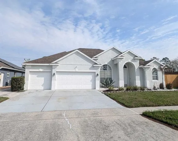 a view of a white house with a yard