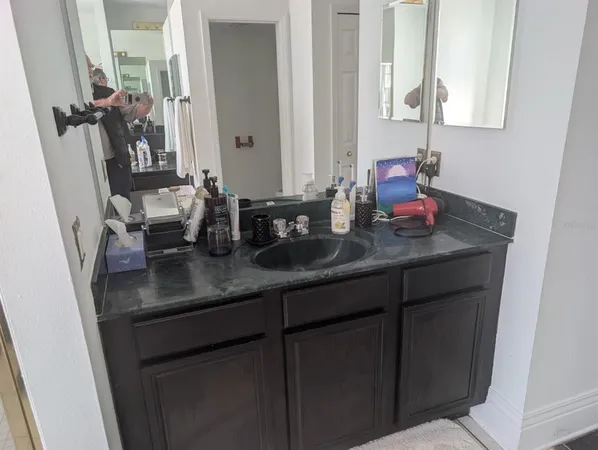 a bathroom with sink a mirror and vanity