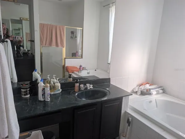 a bathroom with a sink double vanity and a mirror