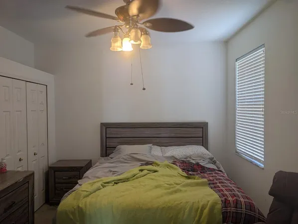 a bedroom with a bed and a chandelier