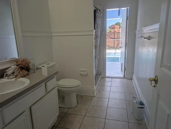 a bathroom with a granite countertop toilet a sink and a shower