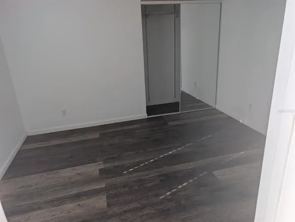 a view of room with wooden floor