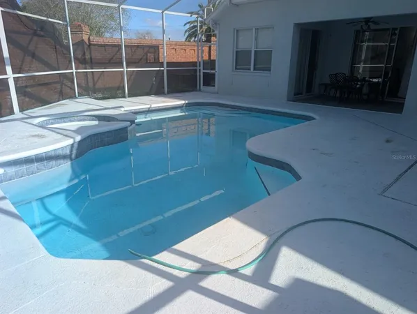 a room with pool table and a window