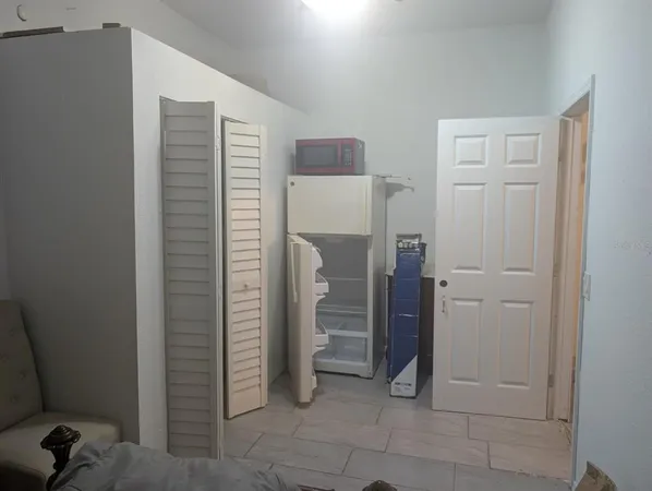 a view of elevator with hallway and closet